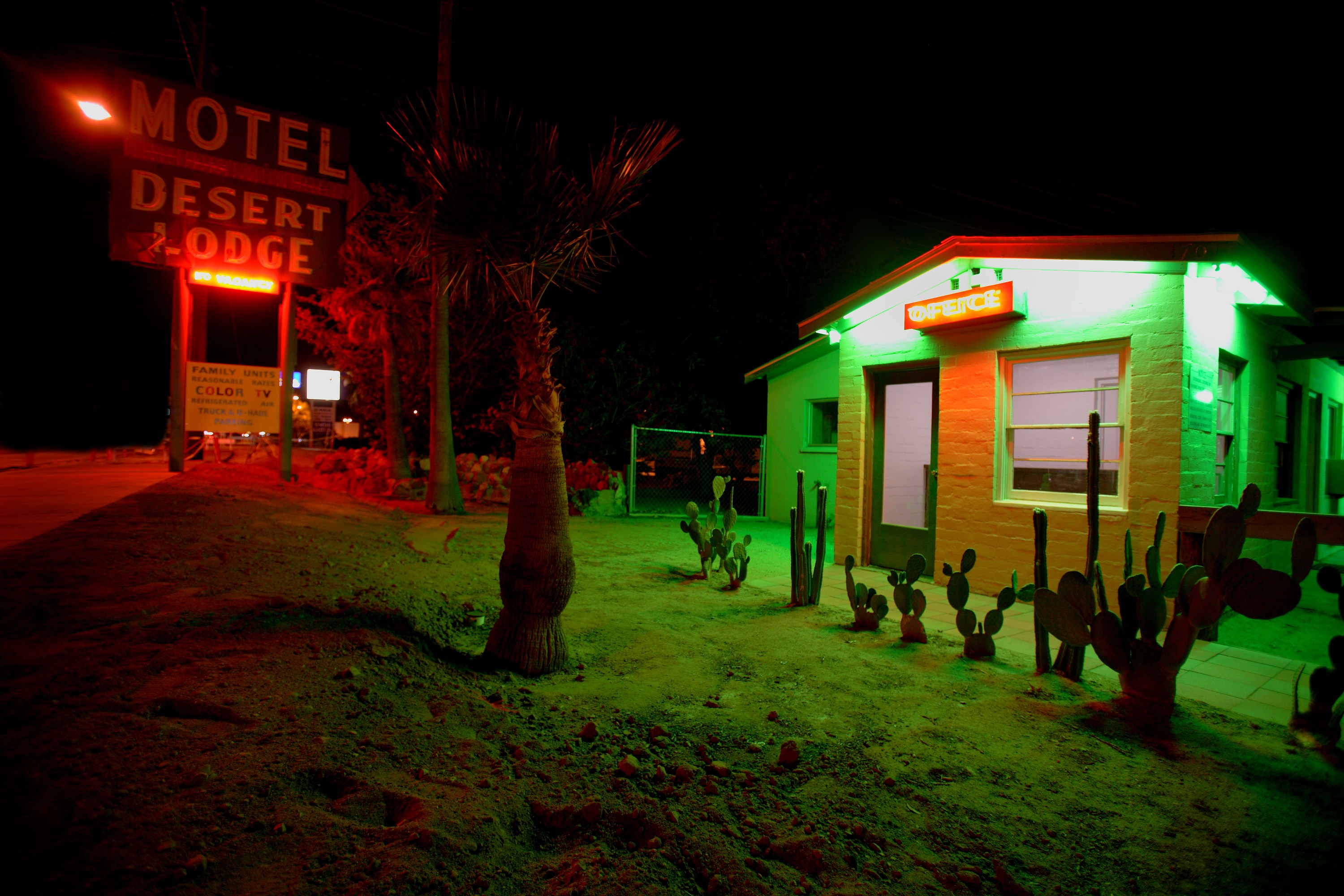 Desert Lodge neon glowing at night along Route 66