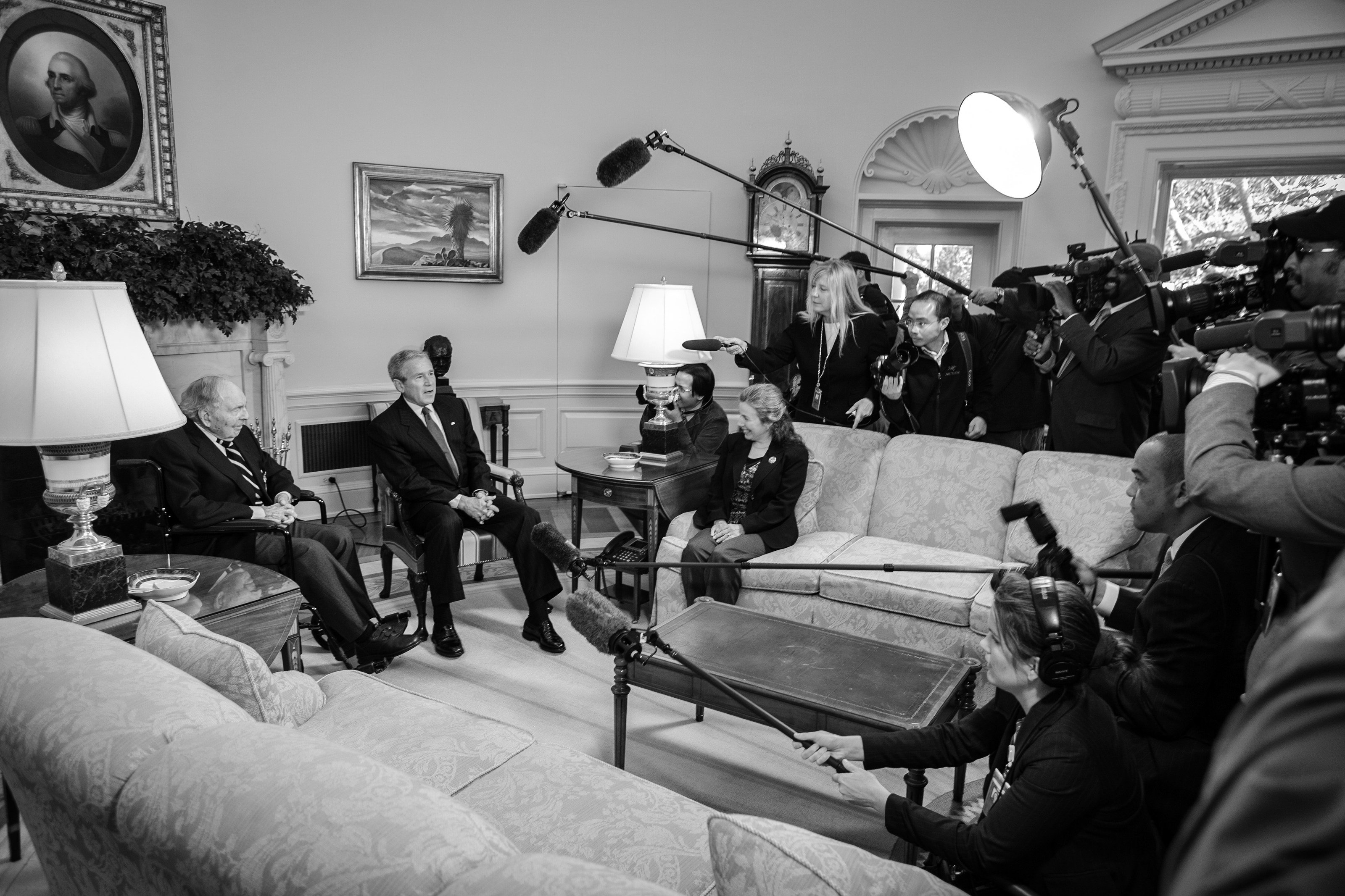 President George W. Bush and Frank W. Buckles seated before a wall of reporters and cameras in the Oval Office